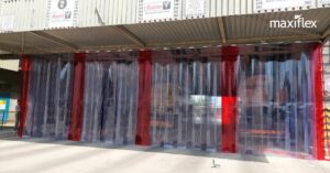 Strip curtain with red safety strips at a animal feed manufacturing plant.