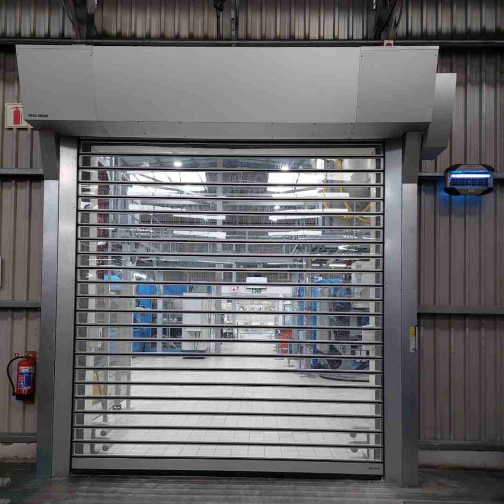 Rigid high speed door with vision slats