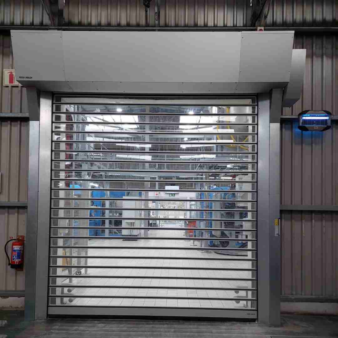 Rigid high speed door with vision slats